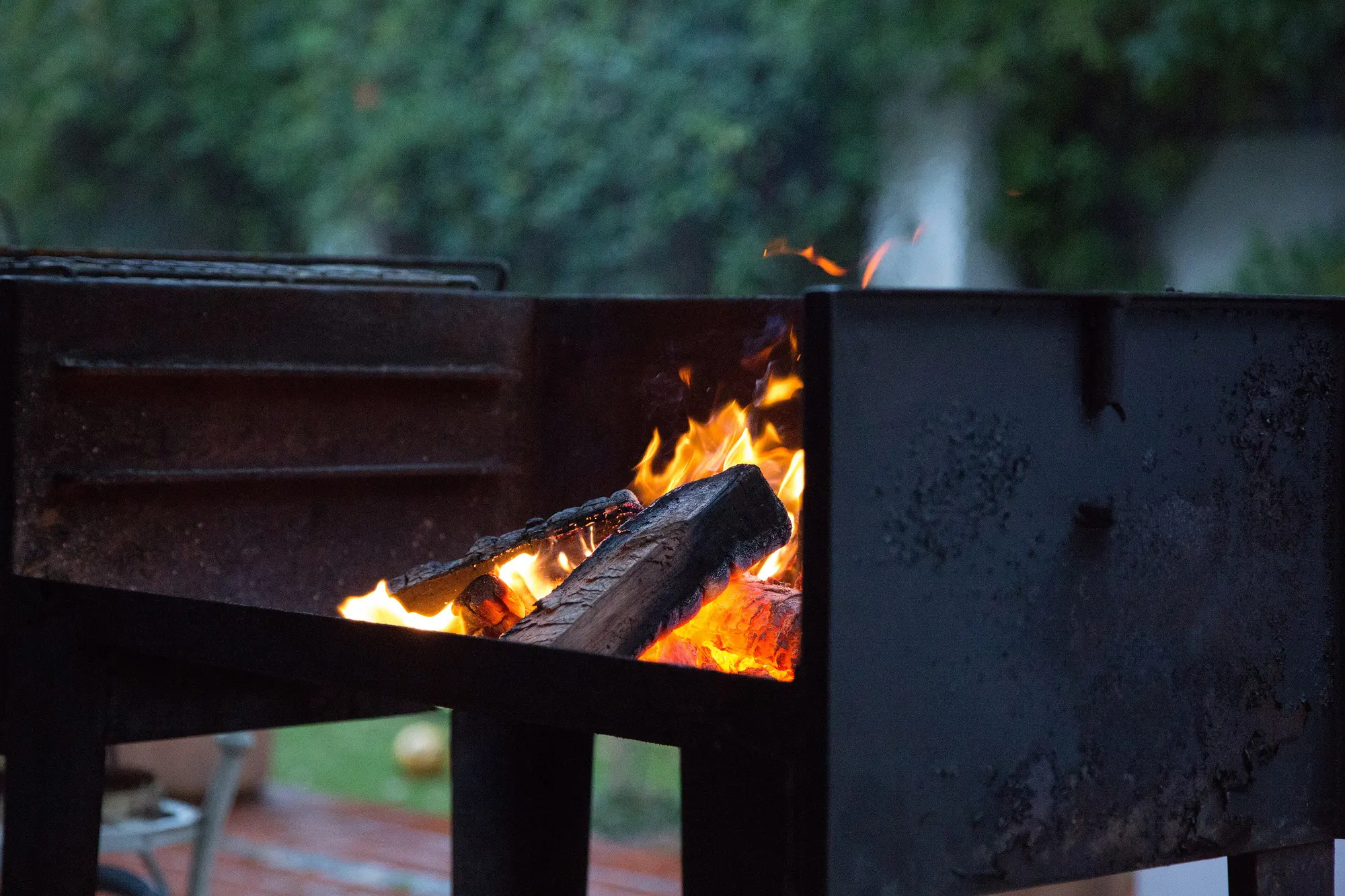 Open wood fire in a built braai in Cape Town, flames and coals